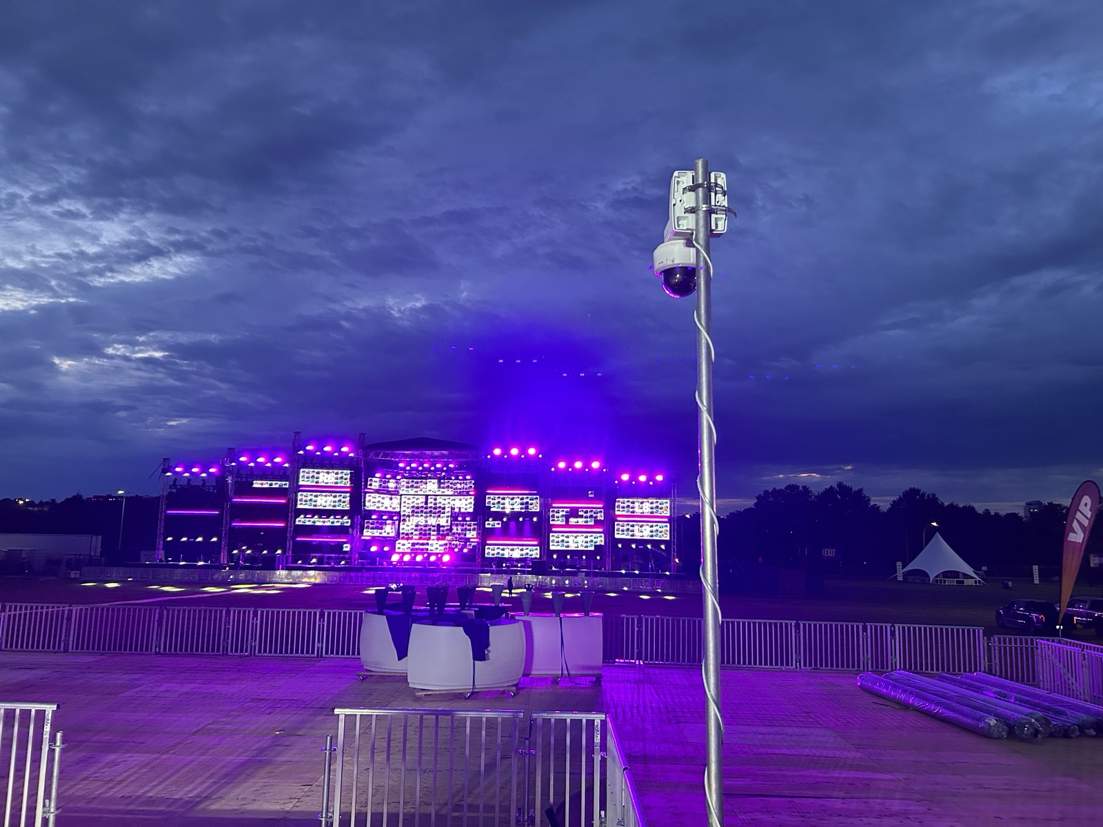Surveillance mast overlooking an illuminated live event at night