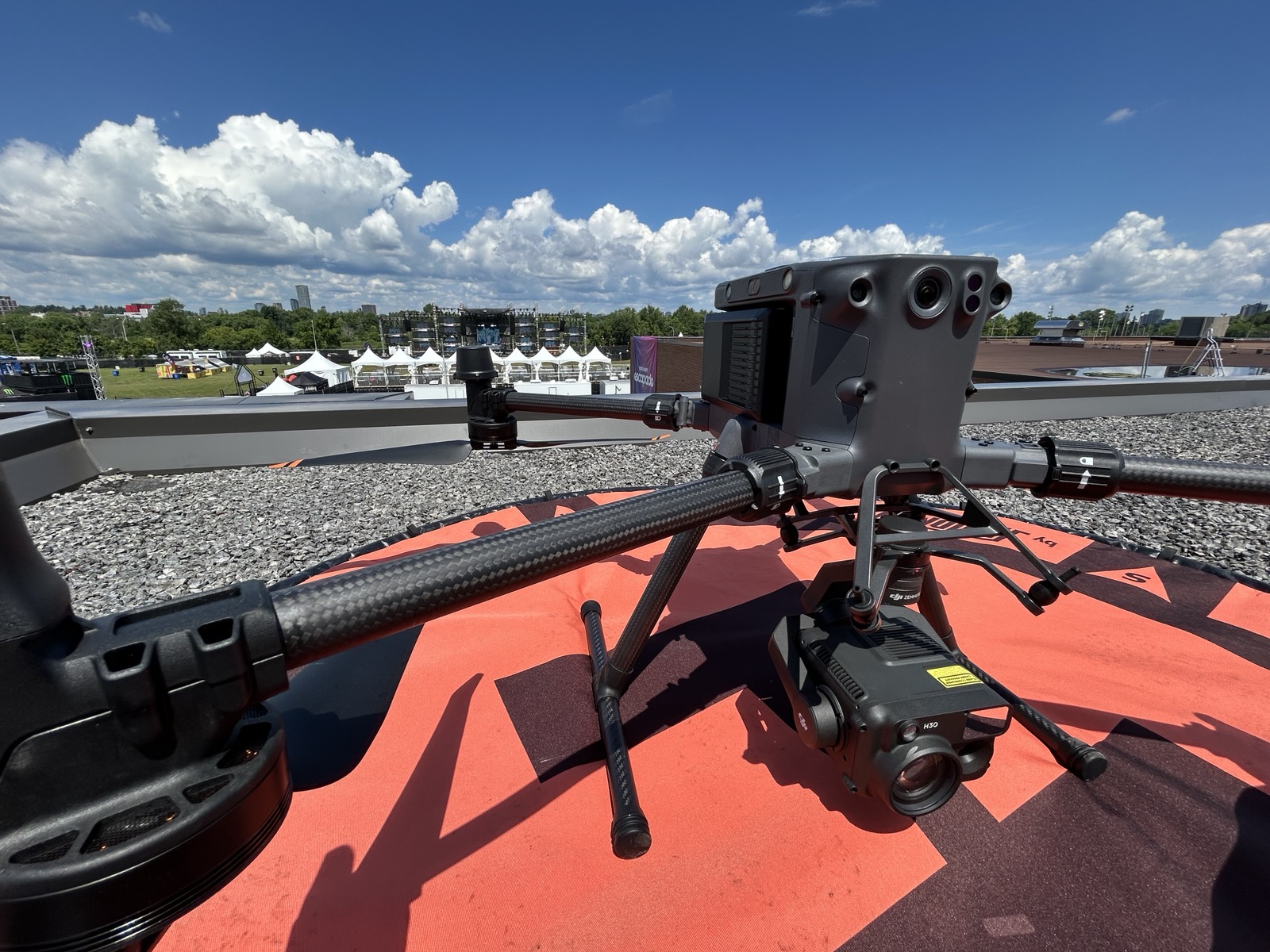 Enterprise drone positioned on a rooftop with the event site visible behind it