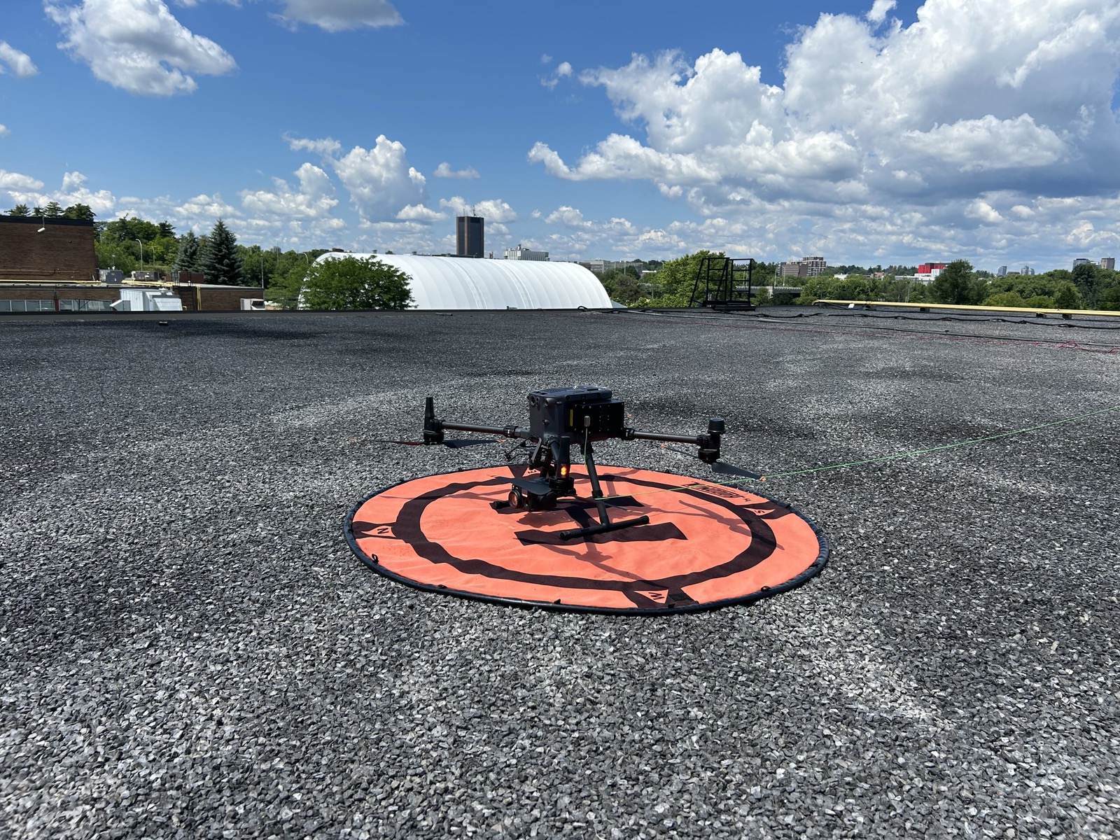 Enterprise drone positioned on a rooftop landing pad during an event deployment