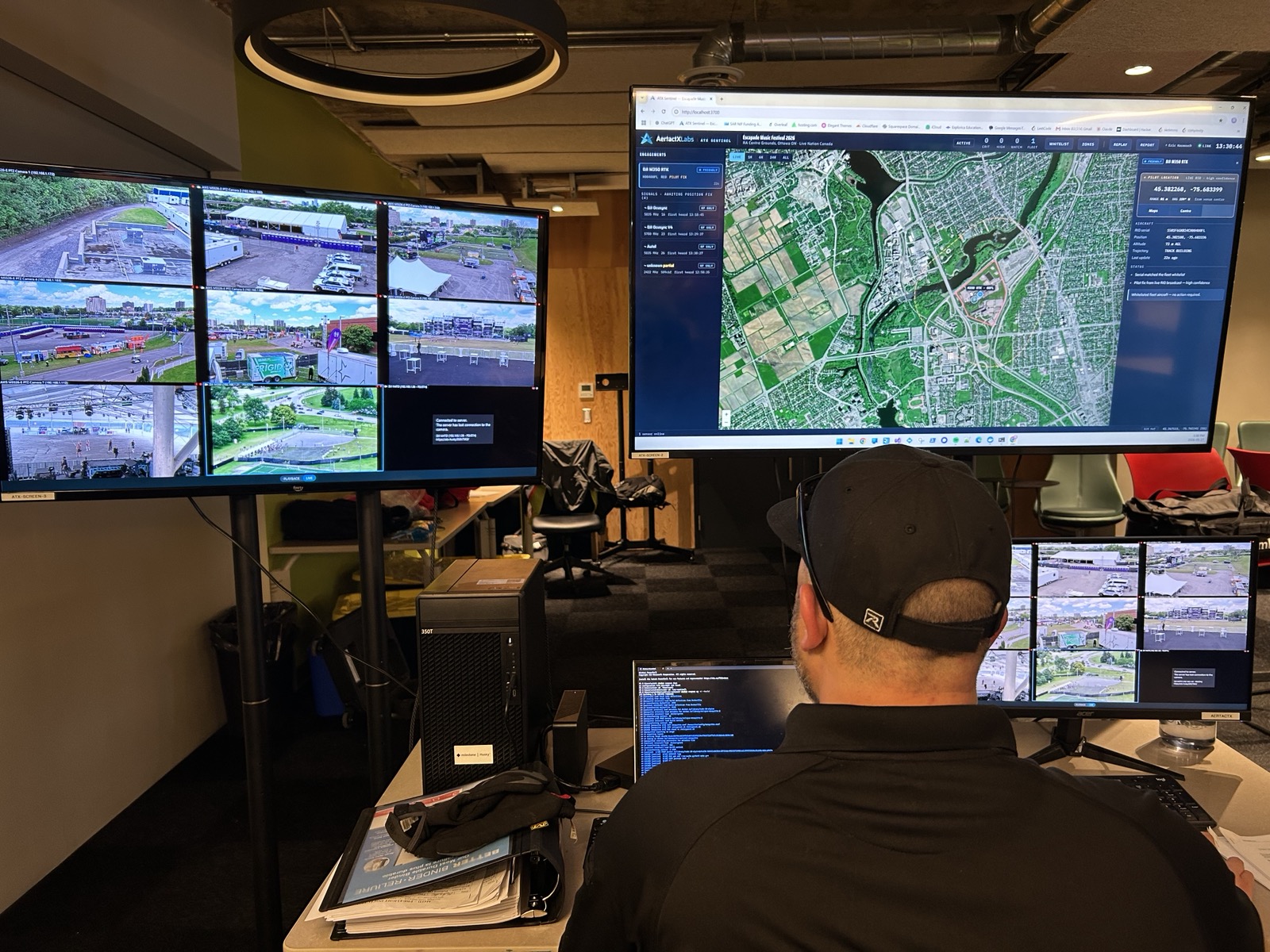 Command centre operator monitoring live surveillance feeds and mapping displays