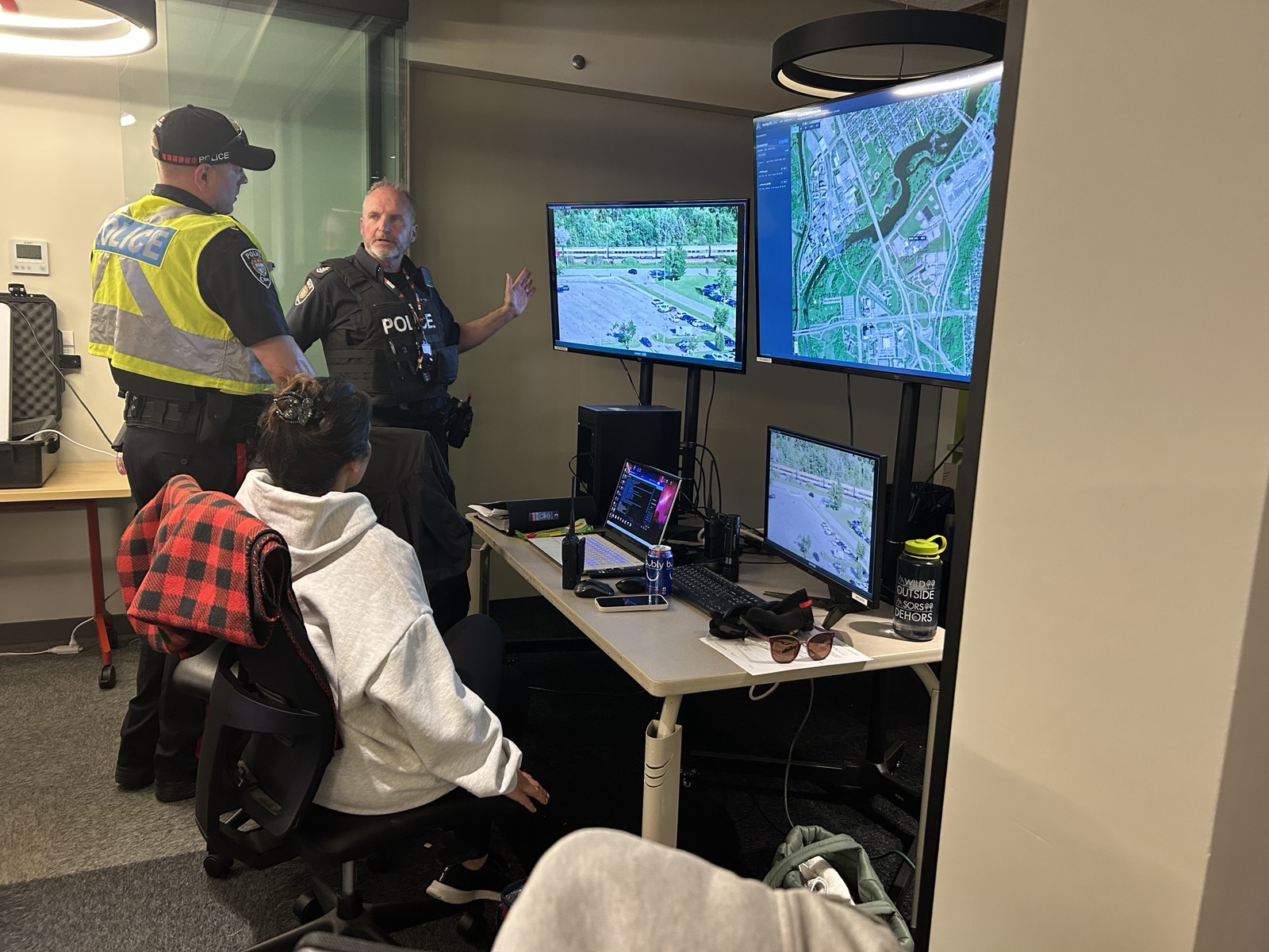 Public safety personnel reviewing live video and mapping in an operations room